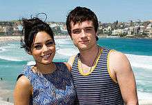 Josh Hutcherson in a striped blue tank top and Vanessa Hudgens in a blue dress.