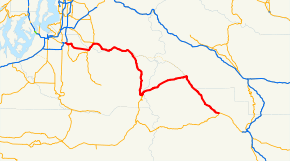 A map of the Cascade Range northeast of Mount Rainier and the surrounding foothills depicting the route of State Route 410 (SR 410, highlighted in red) between Sumner at SR 167 and Naches at U.S. Route 12 (US 12). This was one of the sections that made up US 410, which existed from 1926 until 1967, being replaced with US 12.