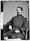 Man with goatee in uniform with two vertical columns of buttons