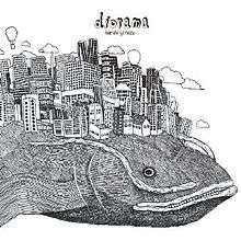 The front half of a catfish is drawn in monochrome pencil. On the whale's back is a city made up of tall buildings. Above the buildings are clouds, and two hot air balloons. The title is written at the top-centre in lower caps, with Kenshi Yonezu written in lower caps romaji underneath.